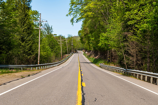 A stretch of a two laned State Route 62 in Tionesta, Pennsylvania, USA on a sunny spring day