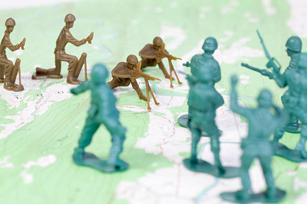 istock Plastic Army Men Fighting on Topographic Map Opposing Sides War 151518069