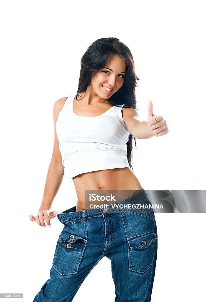 Милая девушка, демонстрируя потеря веса - Стоковые фото Белый фон роялти-фри