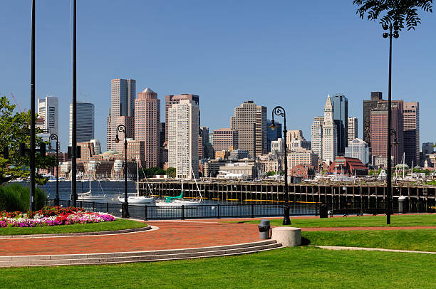 Boston Skyline and Harbor Boston skyline and harbor. Park in foreground, cityscape in the background. east boston stock pictures, royalty-free photos & images