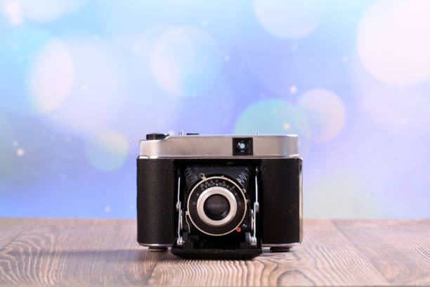 istock Retro camera on a wooden table 1515198840