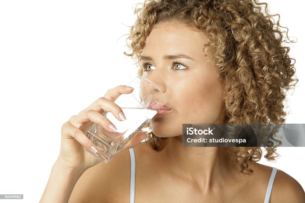 Woman drinking water Young curly haired woman drinking water Water Stock Photo