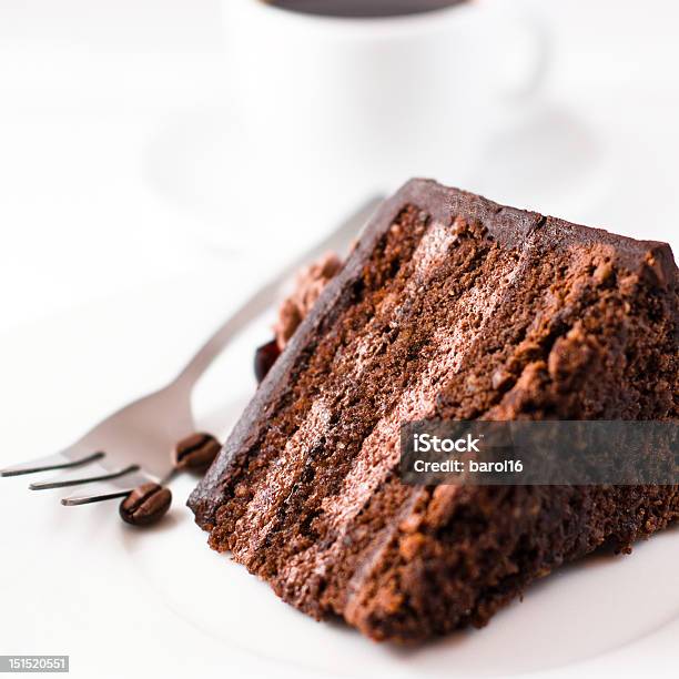 Slice Of Chocolate Cake With Fork And Fruit On White Plate Stock Photo - Download Image Now