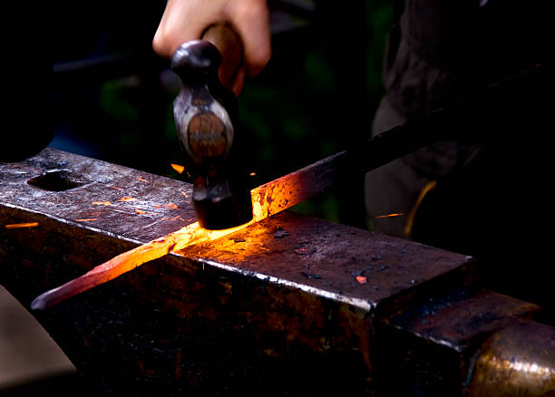 istock Blacksmith hammering a hot metal rod 151520684