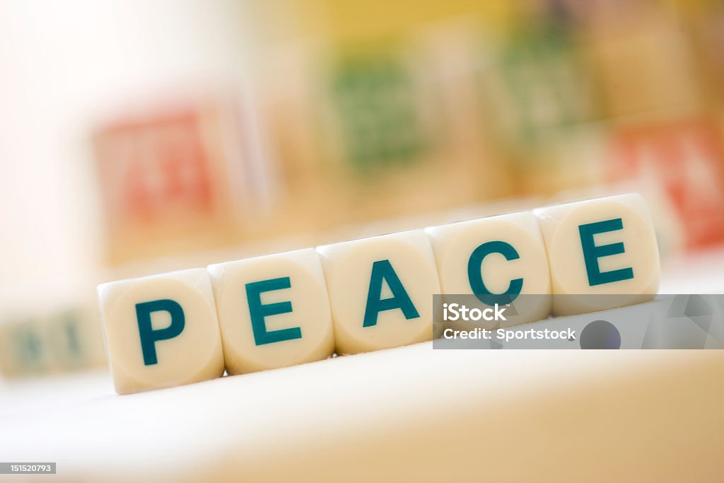 PEACE Spelled With Scrabble Tiles Close-up of word "PEACE" spelled out with Scrabble Tiles. Block Shape Stock Photo