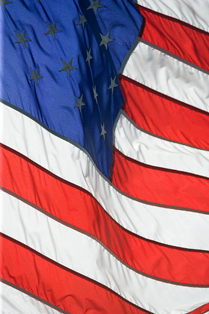 istock American flag flying proudly on a windy day 151521235