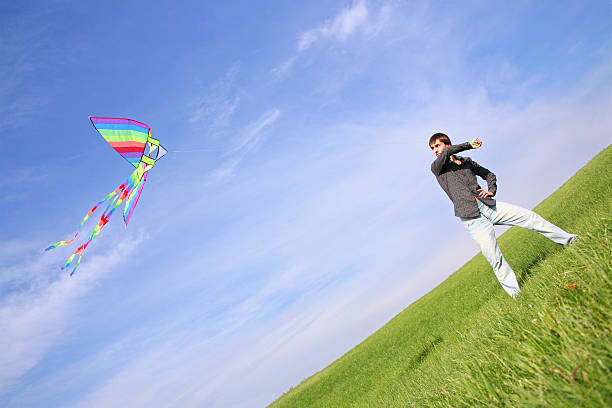 istock young man in black shirt flying multicolored kite 151521925