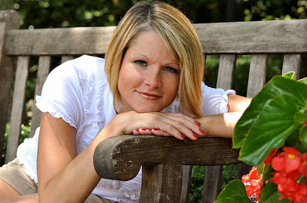 Yong beautiful woman sitting on wooden steps and looking .See related :-