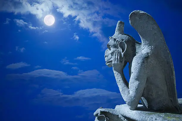 The Stryge, most famous of Chimeras from Notre Dame, looking to the moon.