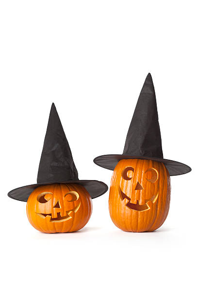istock Two Halloween pumpkins with black hat on white background 151523224