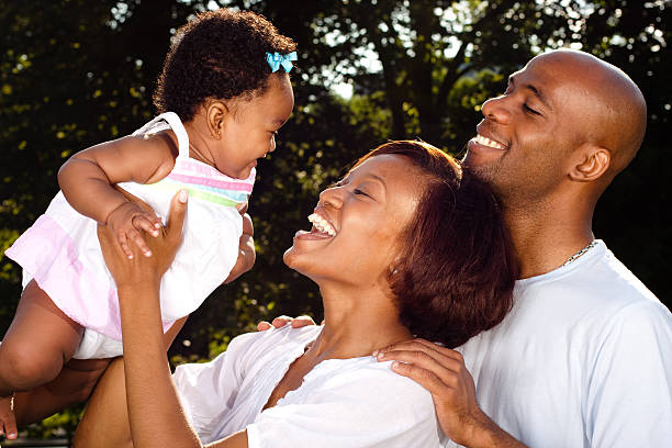 istock new parents holding baby 151523755