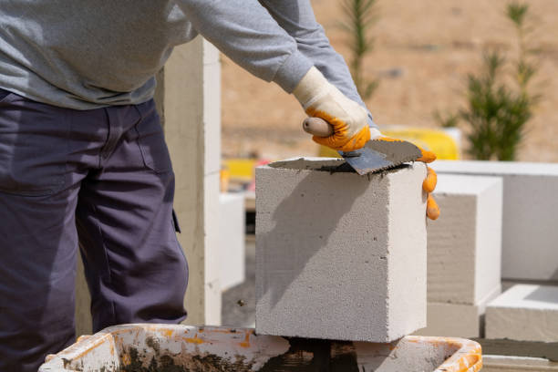 istock The bricklayer is working. Building a wall of aerated concrete. 1515238117