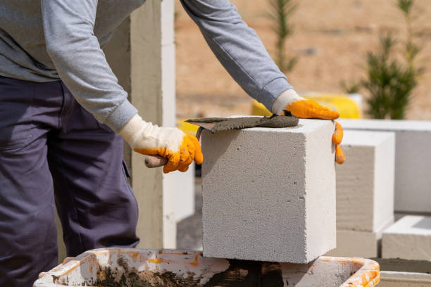 istock The bricklayer is working. Building a wall of aerated concrete. 1515239648
