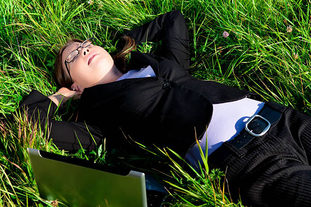 Business Woman Resting in the Grass stock photo