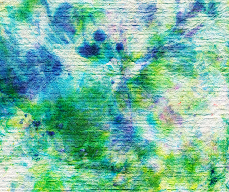 Tie dye style background created with colorful green and blue ink.