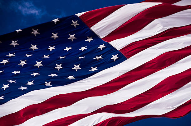 American Flag Against a Blue Sky stock photo