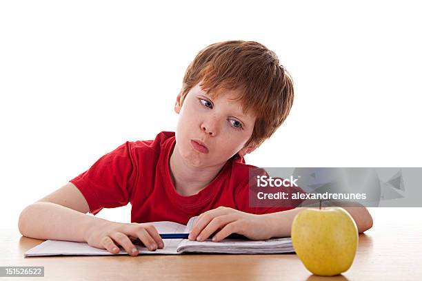 Boy Studying And Distracted With An Apple Stock Photo - Download Image Now - Child, Distracted, Reading