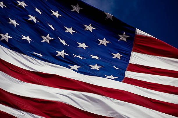 American Flag Against a Blue Sky stock photo