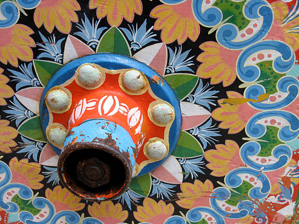 Authentic Costa Rica decorative ox cart, or carreta, located in Guanacaste. The paint job itself is well weathered, with some areas of paint scrapes and damage.