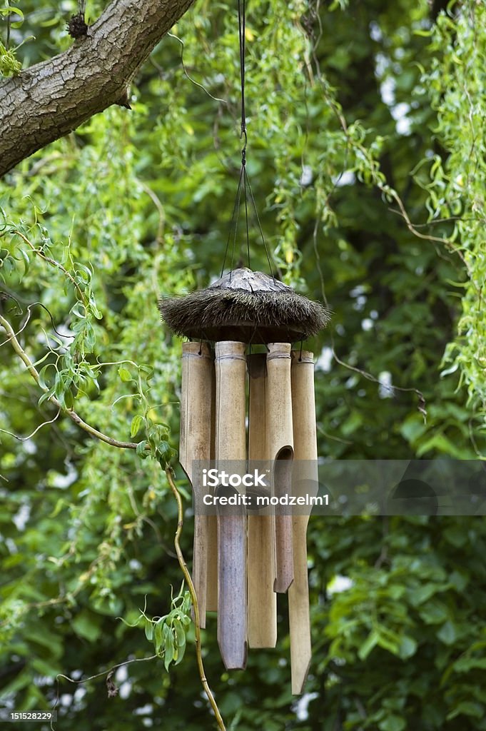 Wind chimes Bamboo wind chimes on a natural green bacground. Wind Chime Stock Photo