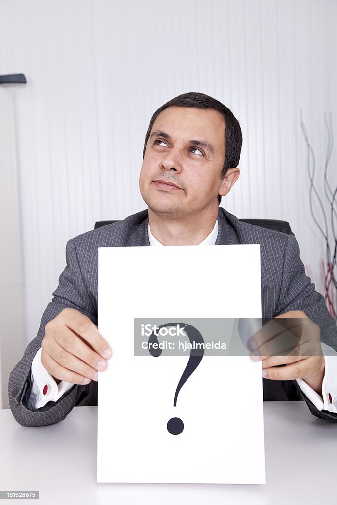 Businessman question Businessman at the office with a big question Adult Stock Photo