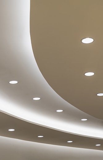 Ceiling with Curved LED lights. Circle cove light decoration, recessed ceiling luminaires. Space for text, Selective focus.