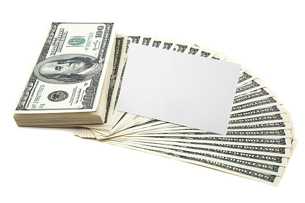 Spread of cash with blank card for text stock photo