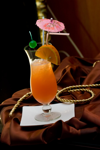 Fresh iced cocktail garnished orange and umbrella