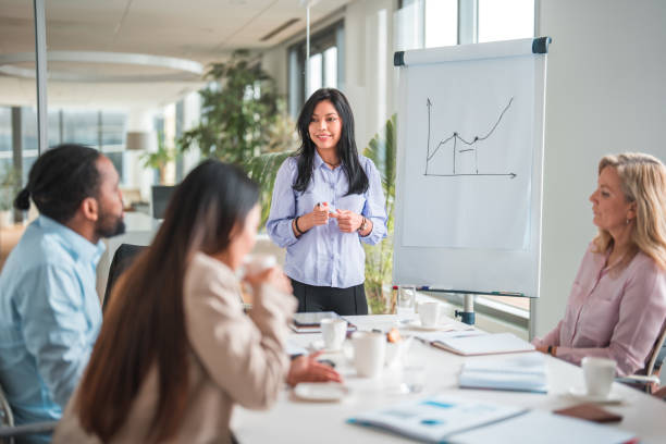 istock Attractive Latina Intern Showing her Business Plan to CEOs 1515302031