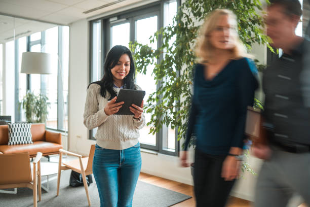 istock Mid Adult Latina Using a Digital Tablet in Office Common Space 1515303065