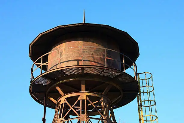 Old rusty water tower at a railwaystation
