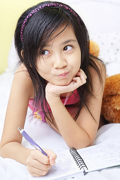 istock Little girl writing her diary 151530901