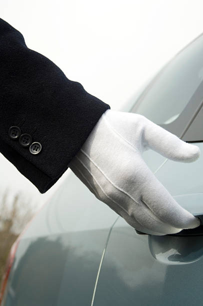istock White gloved uniformed hand opening car door 151531546