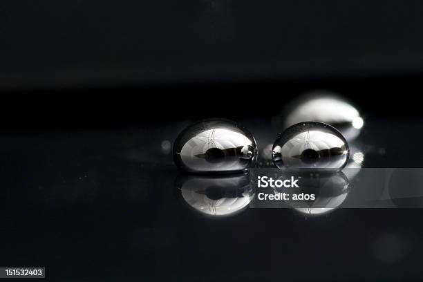 Three Drops Of Mercury Lying On A Black Surface Stock Photo - Download Image Now - Mercury - Metal, Metal, Silver - Metal