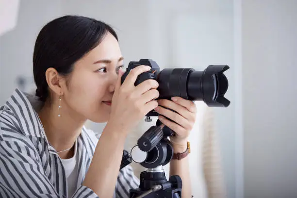 Photo of Japanese young woman working as a photographer