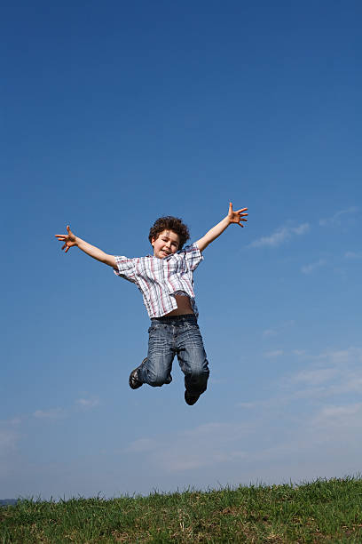 istock Boy jumping outdoor against blue sky 151532958