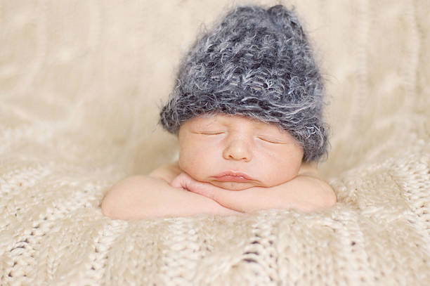 istock Newborn Sleeping in a Knit Hat 151532997