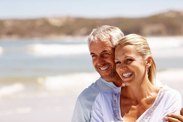 istock Happy mature couple enjoying at beach 151533060