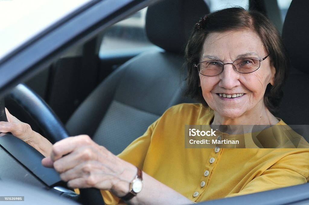 Senior woman driving car Active senior woman - smiling retired lady driving car, detail Active Lifestyle Stock Photo