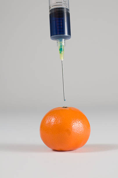 Injecting a Tangerine stock photo