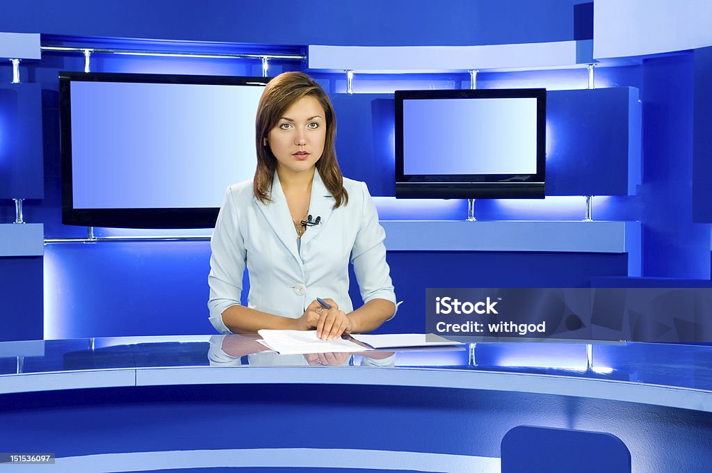 television anchorwoman at TV studio television anchorwoman at studio during live broadcasting Newscaster Stock Photo