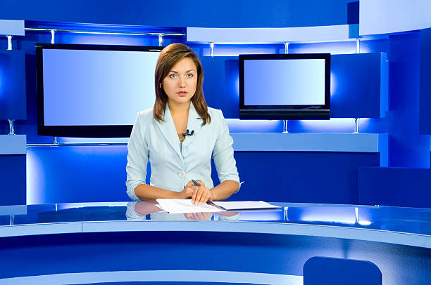 television anchorwoman at TV studio television anchorwoman at studio during live broadcasting newscaster photos stock pictures, royalty-free photos & images