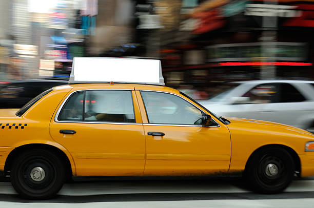 Taxi Billboard in Times Square Yellow taxi billboard with clipping path. Crowded with commercial signs, there is intense competition for attention in Times Square, New York City. taxi photos stock pictures, royalty-free photos & images