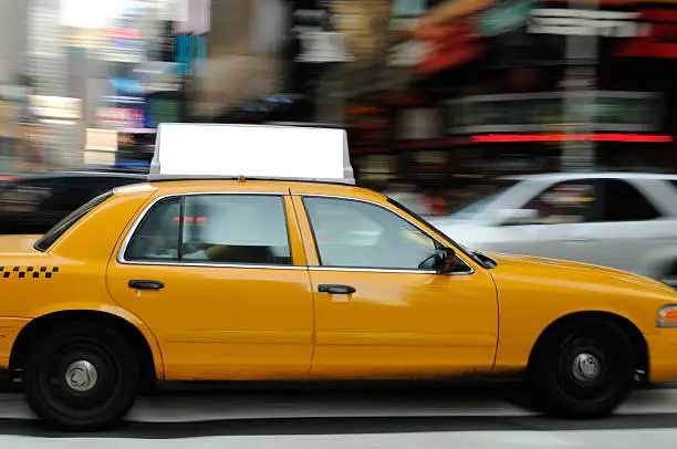 Yellow taxi billboard with clipping path. Crowded with commercial signs, there is intense competition for attention in Times Square, New York City.