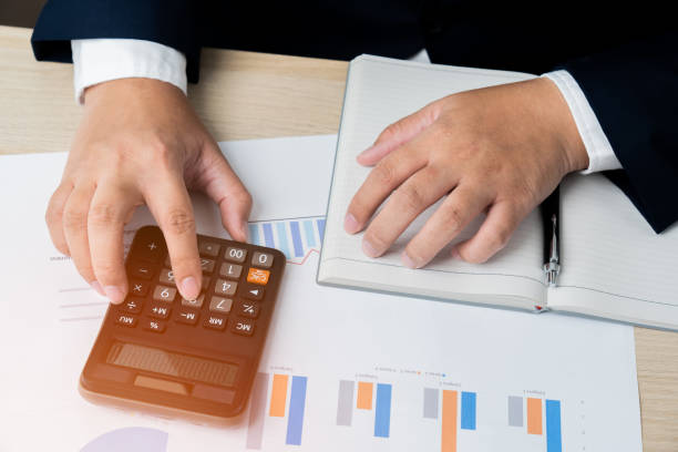 istock Business man calculating financial budget using calculator 1515363517