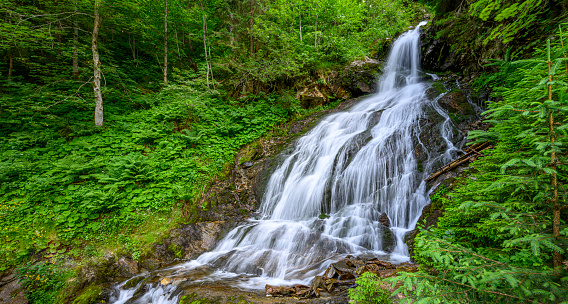 Beautiful waterfall in the mountains of the Alps. Silbertal, Montafon, Vorarlberg