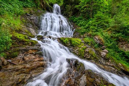 Beautiful waterfall in the mountains of the Alps. Silbertal, Montafon, Vorarlberg