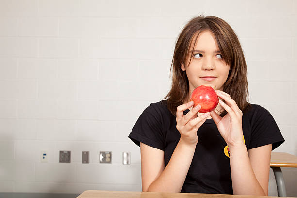 Student holding apple stock photo