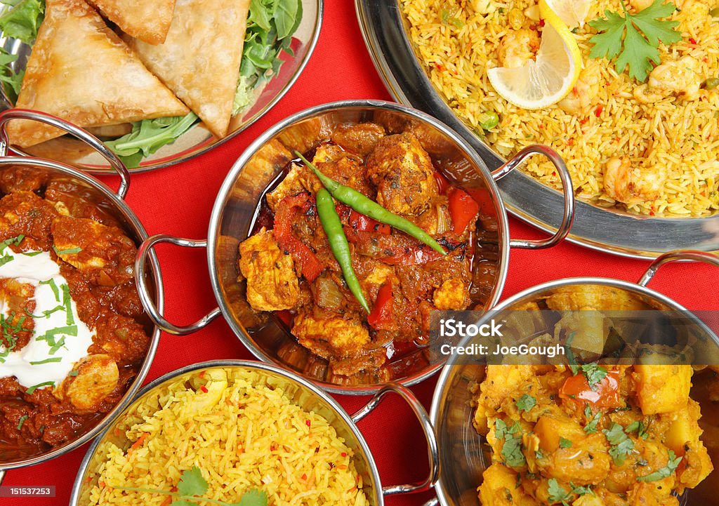 Indian Curry Meal Banquet Selection of Indian curry dishes including prawn biriani, chicken jalfrezi, madras, Bombay aloo, vegetable samosas and rice. Indian Food Stock Photo