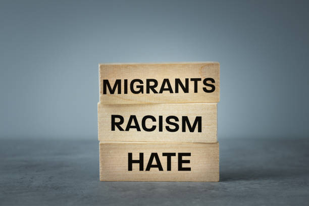 istock The problem of racism and hate migrants, Written on wooden blocks Migrants Racism Hate, Sad gray background, copy space, Concept related to immigrants and hate language 1515373355